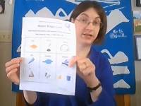 Person holding a sheet of white paper with the words "Water Bingo" written on it.