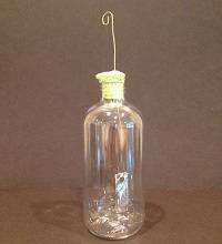 Example electroscope: small plastic bottle with a sponge into its neck and two pieces of foil hanging inside the bottle.