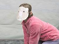 Child wearing a brown marmot mask.