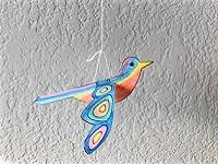 Bird cut-out decorated with colored pencils and hanging by a string.
