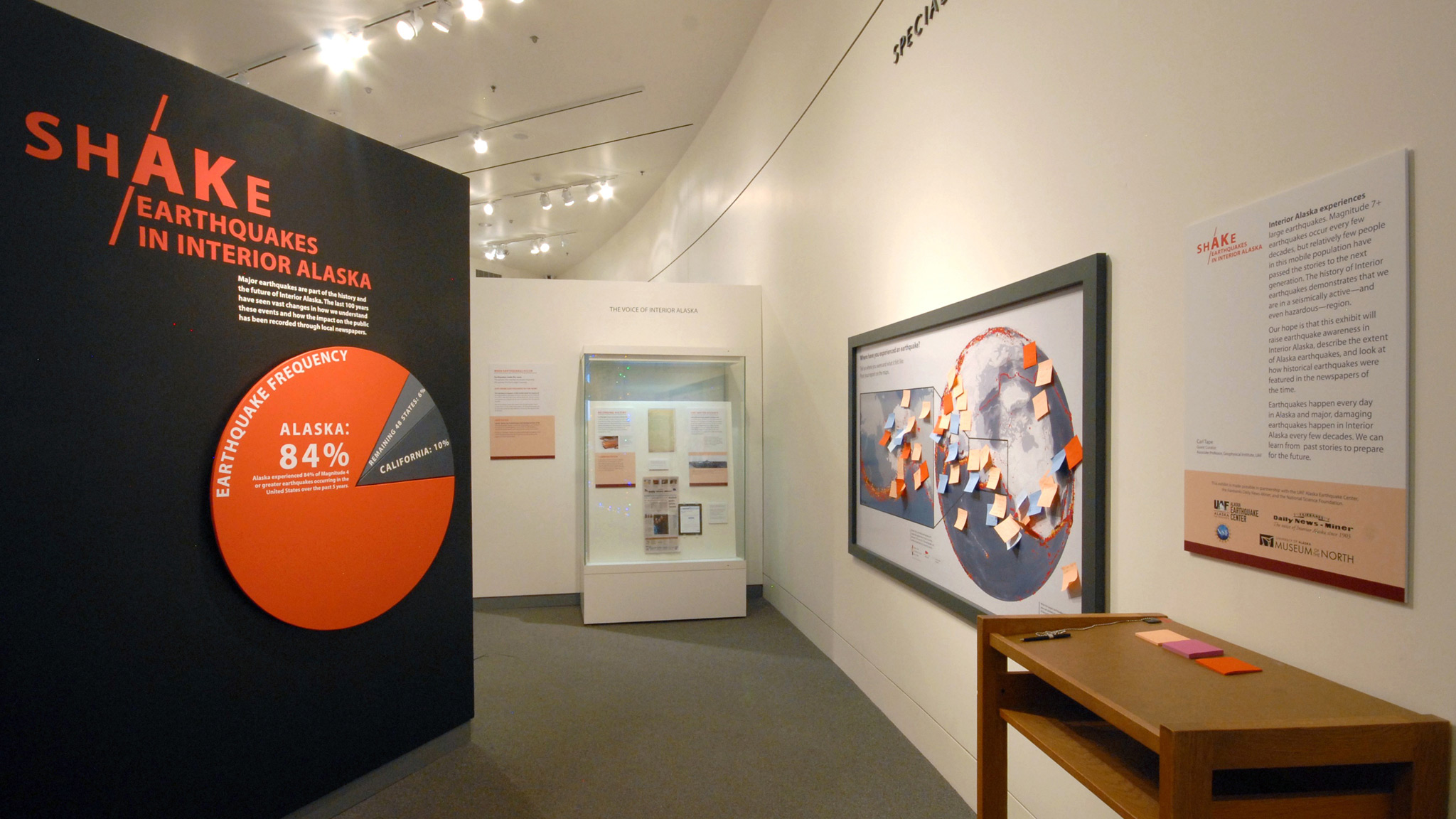 ShAKe from the gallery entrance, showing the exhibit introduction and the maps where visitors wrote and posted their own experiences with earthquakes around the world.