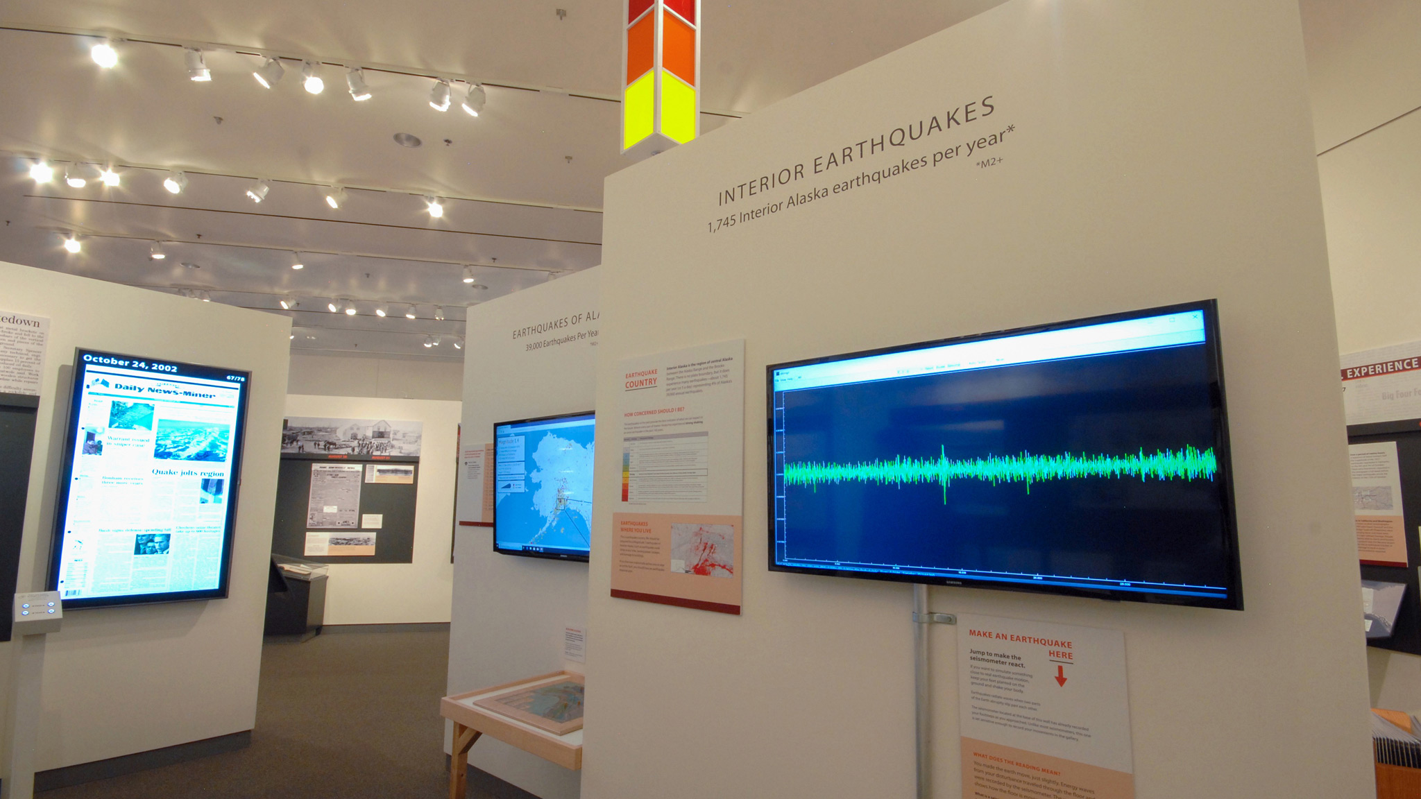 The exhibition’s stomp station, where visitors made and observed (very minor) earthquakes of their own. Above, the yellow light indicates a recent earthquake somewhere in Alaska.