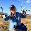 Researcher holding bones, skull with antlers