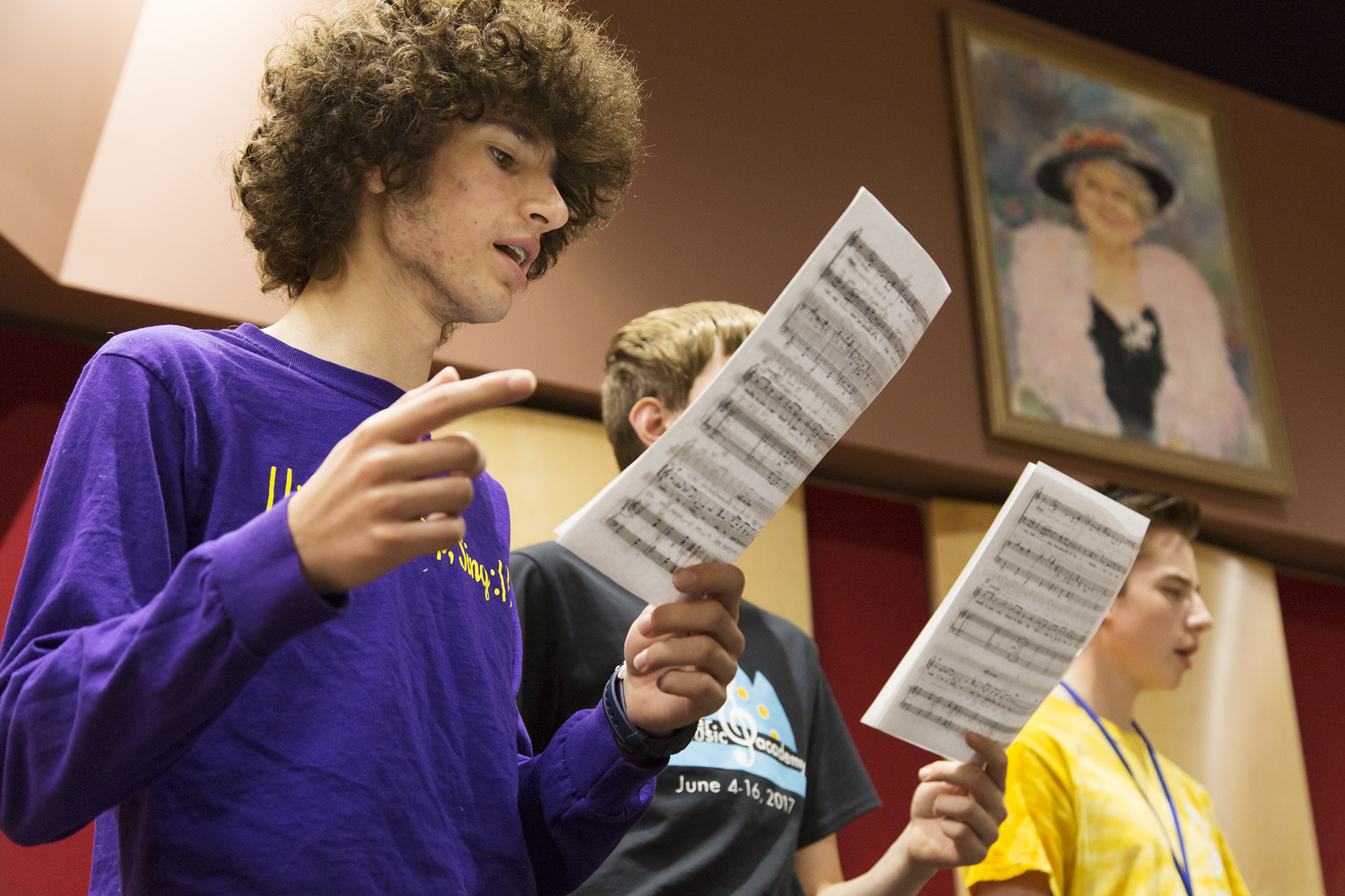 Students at the Summer Music Academy sing from sheet music