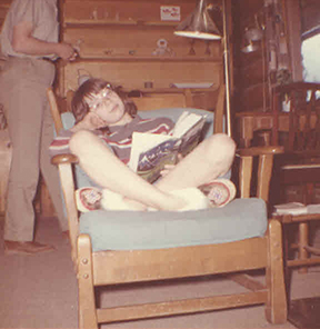 Catherine Madsen, age 11, reading in a chair during the summer she lived in Dogpatch | Photo by Cora Maden