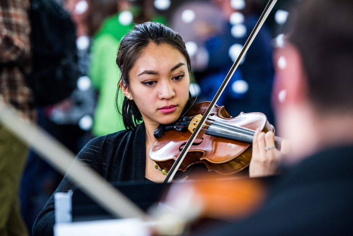 A violinist performs at the annual holiday party | UAF Photo by Zayn Roohi