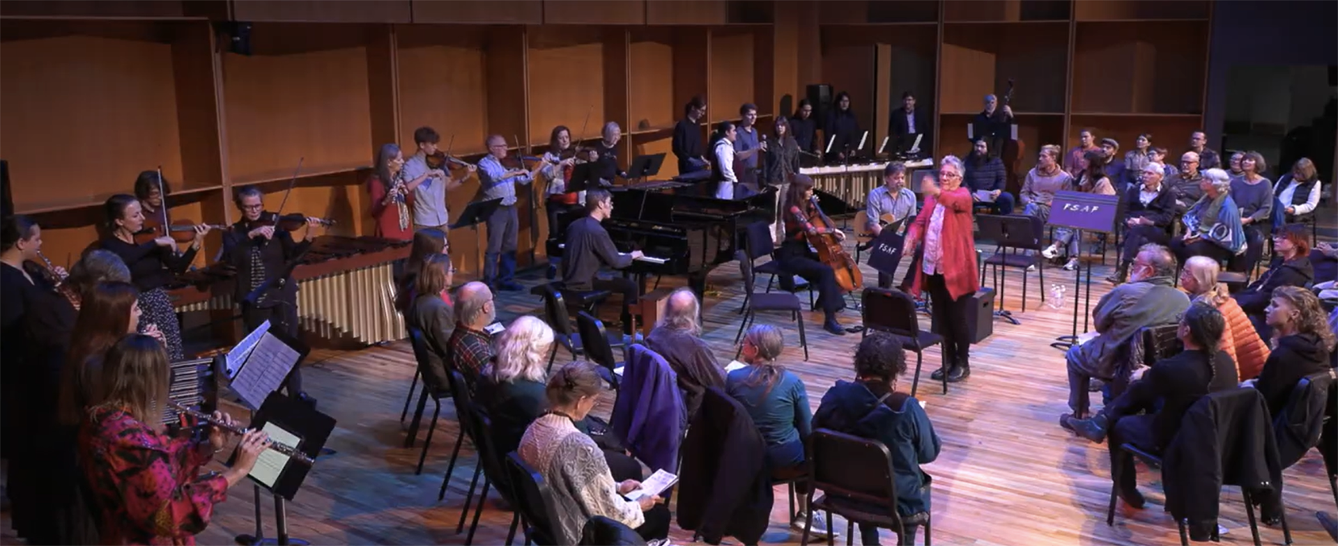 Composer Eve Beglarian (in red) joins musicians on stage during Wildshore New Music’s October return to Fairbanks.