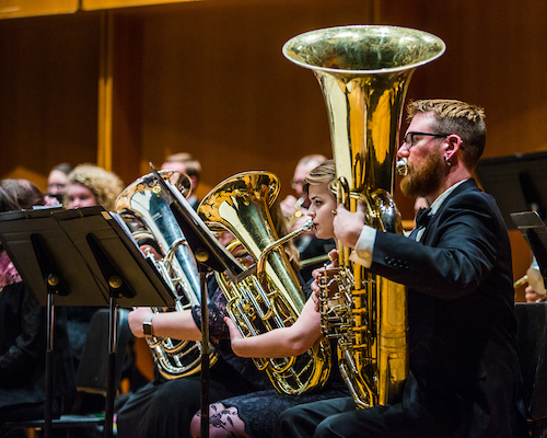 Members of the UAF Wind Symphony warm up prior to their concert on Nov. 18, 2016. | UAF photo by Zayn Roohi