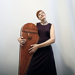 Pauliina Syrjälä poses with kantele | photo by Ulla Nikula, taken from artist's webpage