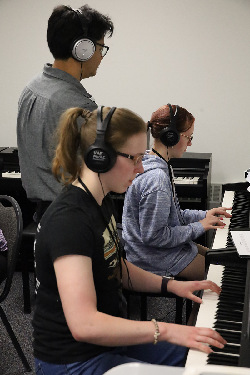 Two students play the piano during the 2026 Summer Music Academy. UAF Photo by Jaunelle Celaire