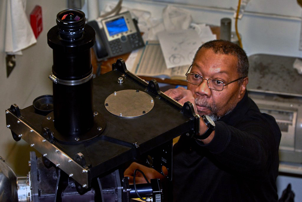  Photo by Mark Conde.Greg Shipman, Instrument Development Services shop manager at the Geophysical Institute, adjusts a part on the scanning Doppler imager.
