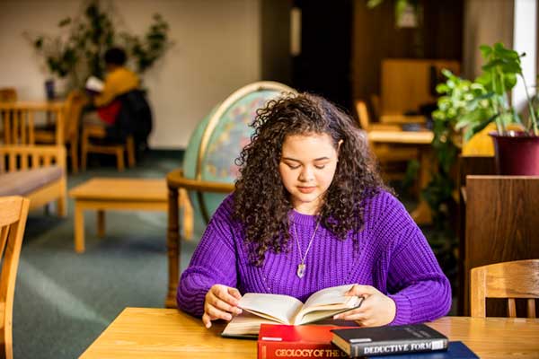 Cyan Woodward reading in the Rasmuson Library