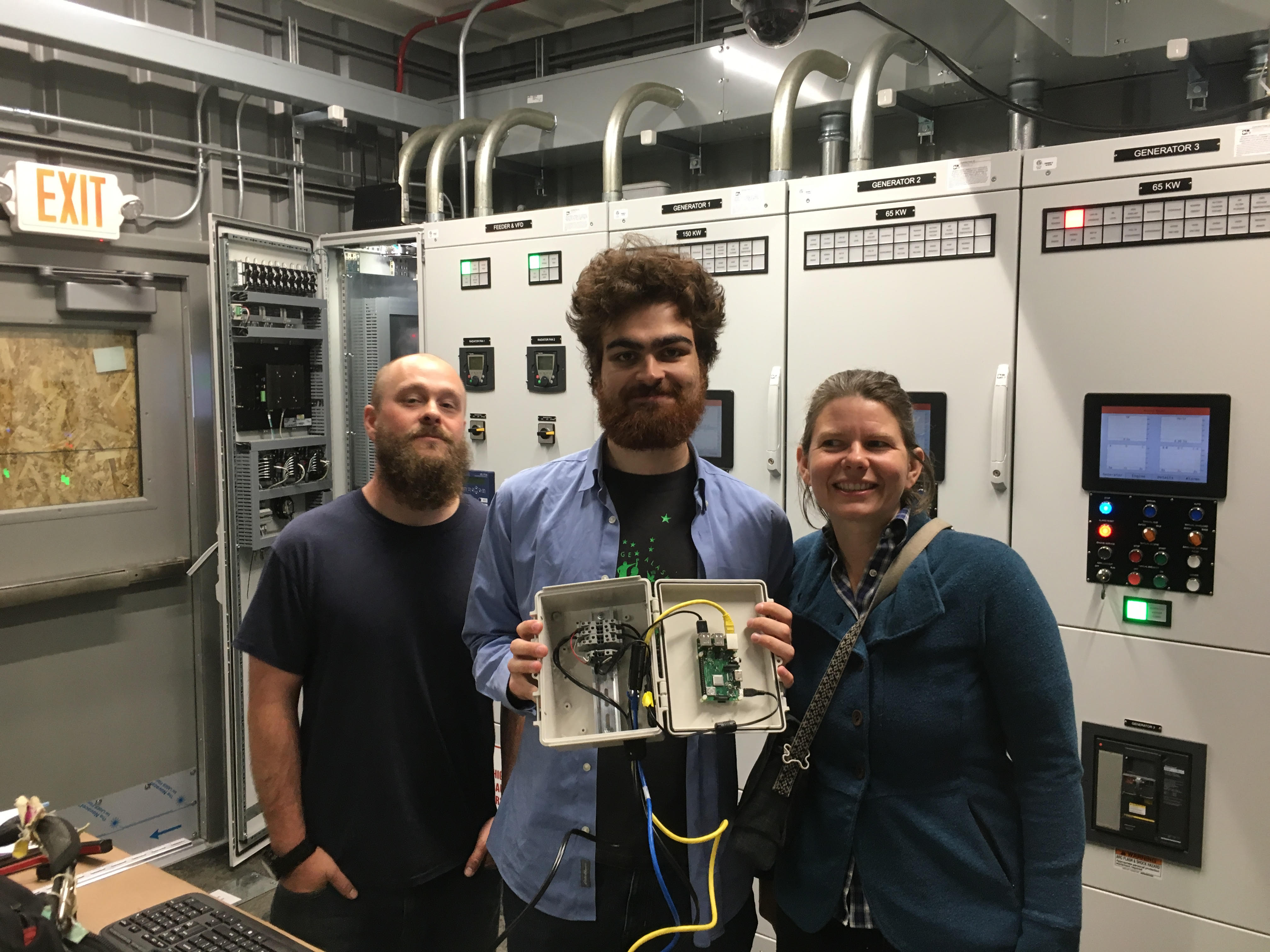 Three people stand together 