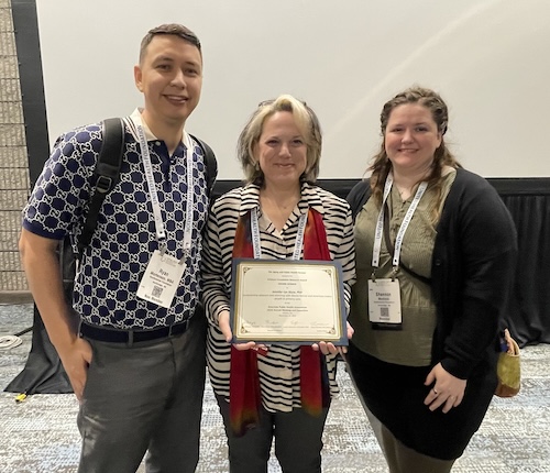 Jennifer Shaw receives the Erickson Foundation Award for Excellence in Research at the American Public Health Association annual meeting in Atlanta, Georgia, on Nov. 14, 2023.