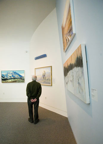 A man gazes at a painting.