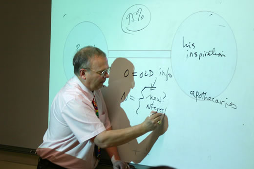 George Guthridge writes on a whiteboard.