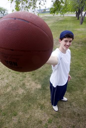 Jordan Jeffery holds up a basketball to the camera.