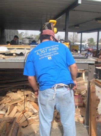 Temple Dillard operates a power saw at the Habitat warehouse. Photo by Clarissa Ribbens.