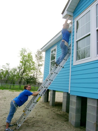 Tabitha Johnson and Emily Schooley 'on the ladder' work together to get the job done. Photo by Erica Schooley