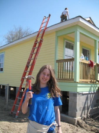 Megan Richards shows off her hammer after putting it to good use. Photo by Brian Lyke.