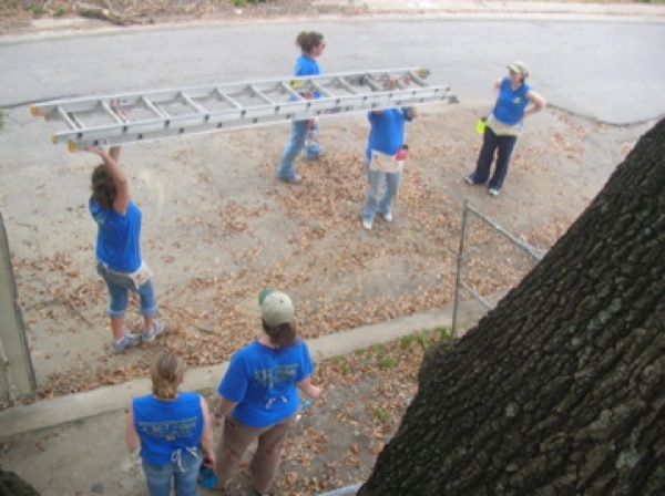 Erica and Emily Schooley, Tabitha Johnson, Megan Richards, JJ Boggs, Cynthia Lashinski and Renee Pasker clean up the site after a hard day%27s work. Photo by Clarissa Ribbens