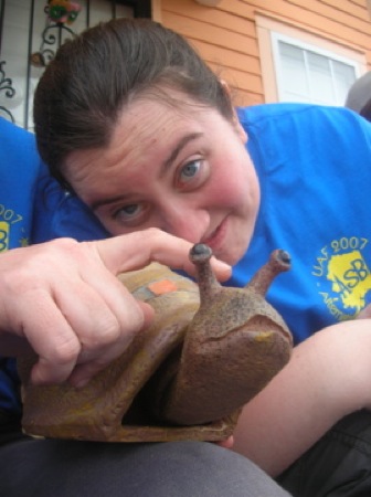 Kari Pile kids around with a snail sculpture. Photo by Clarissa Ribbens