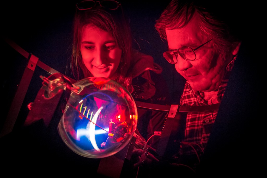 Physics majors Haley Nelson, left, and Stanley Edwin experiment with artificial aurora in the Reichardt Building lab.