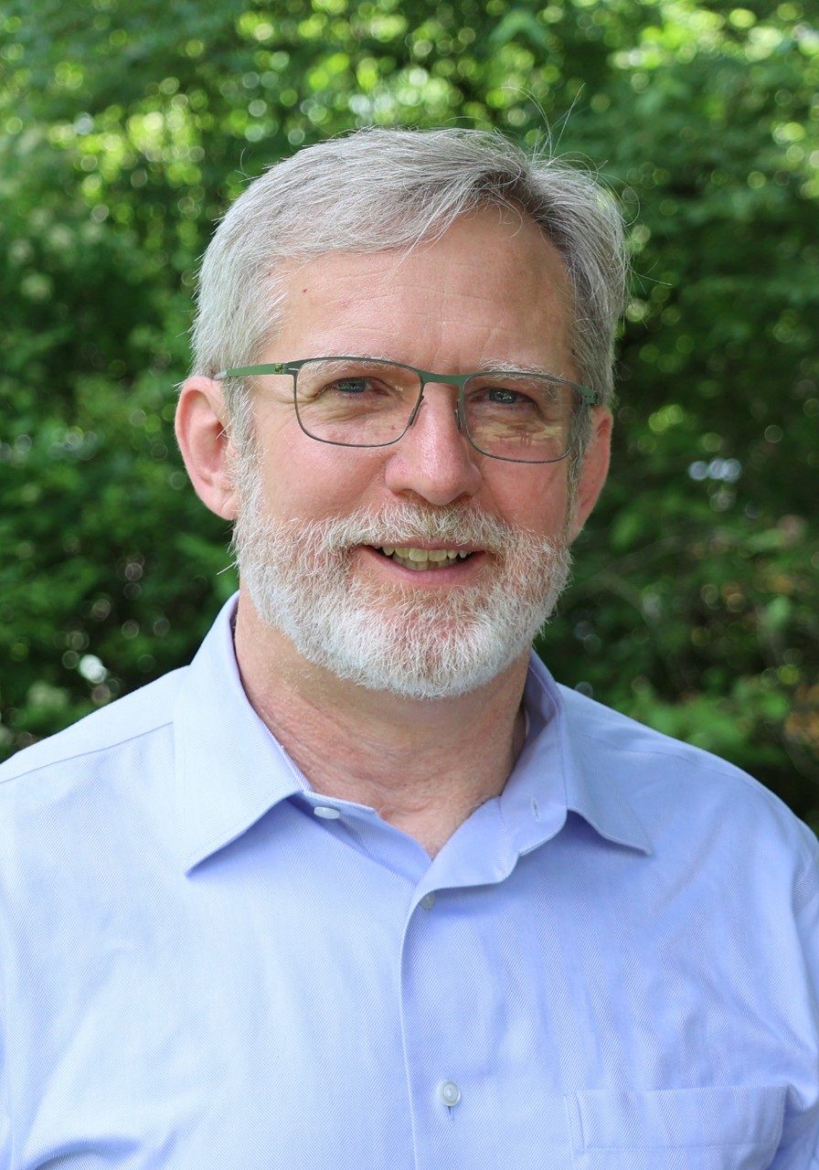 A man with glasses, white hair and beard, Brian Bond