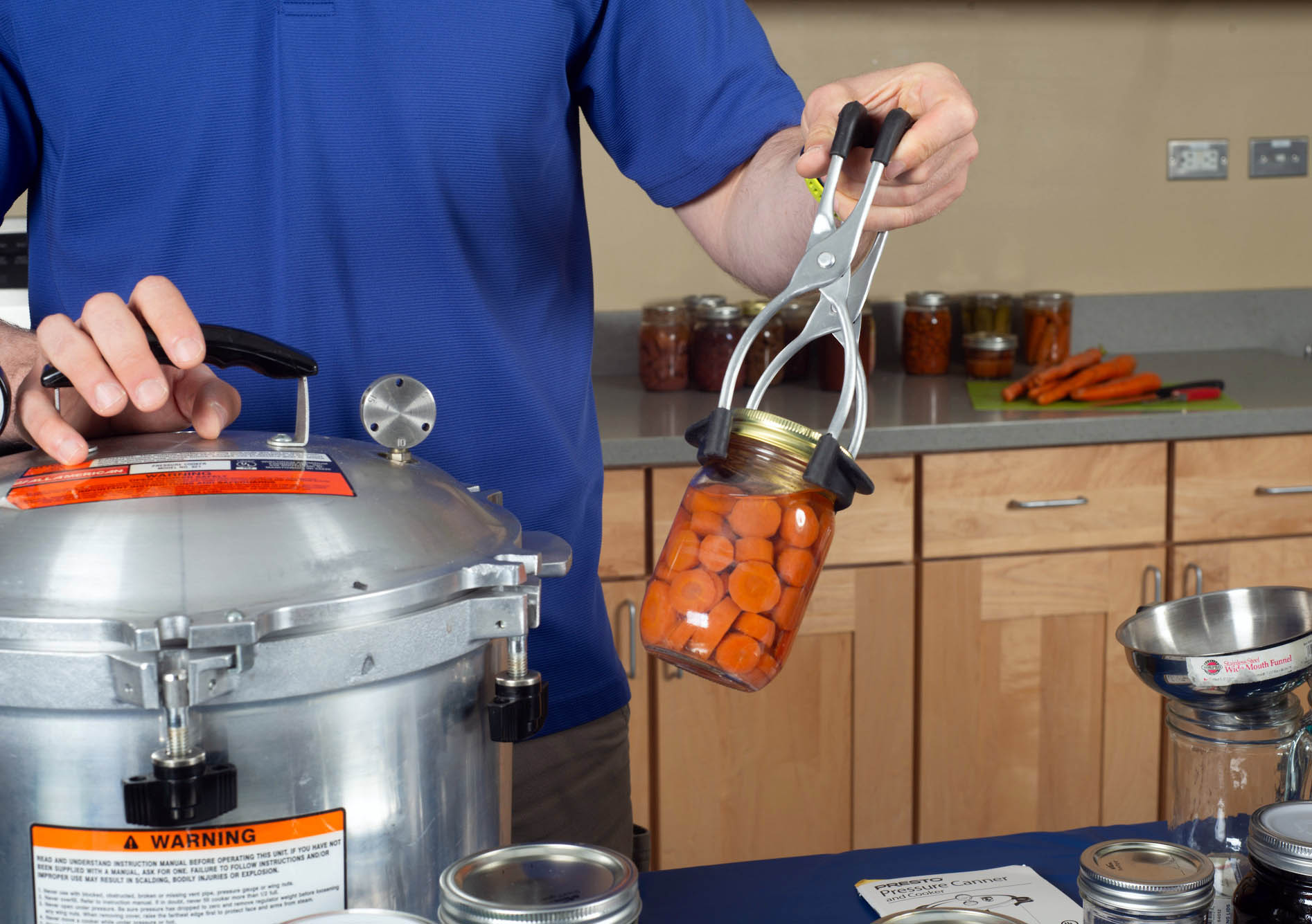 A jar of carrots is ready to be cooked in the pressure canner