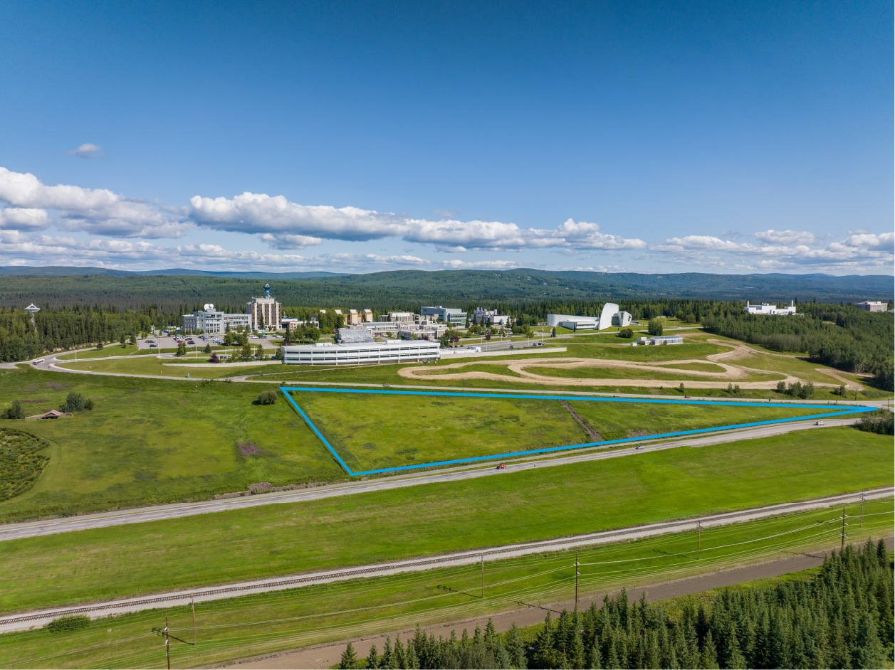 A triangular plot is outlined on an aerial shot of a college campus on a hill