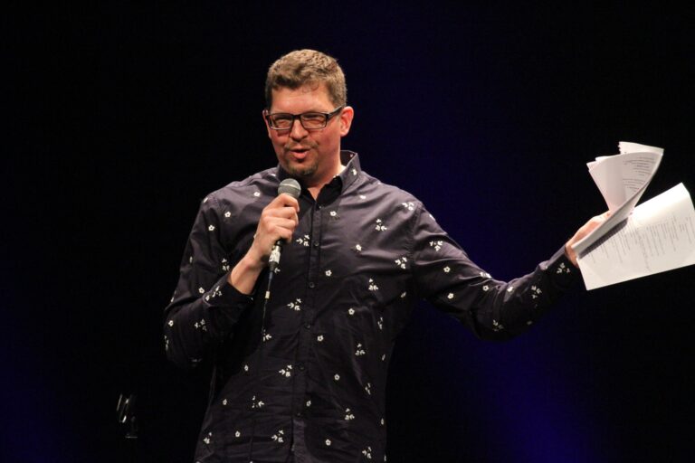 Rob Prince, UAF Communication and Journalism professor and Dark Winter Nights host emcees the live event on stage at Hering Auditorium.