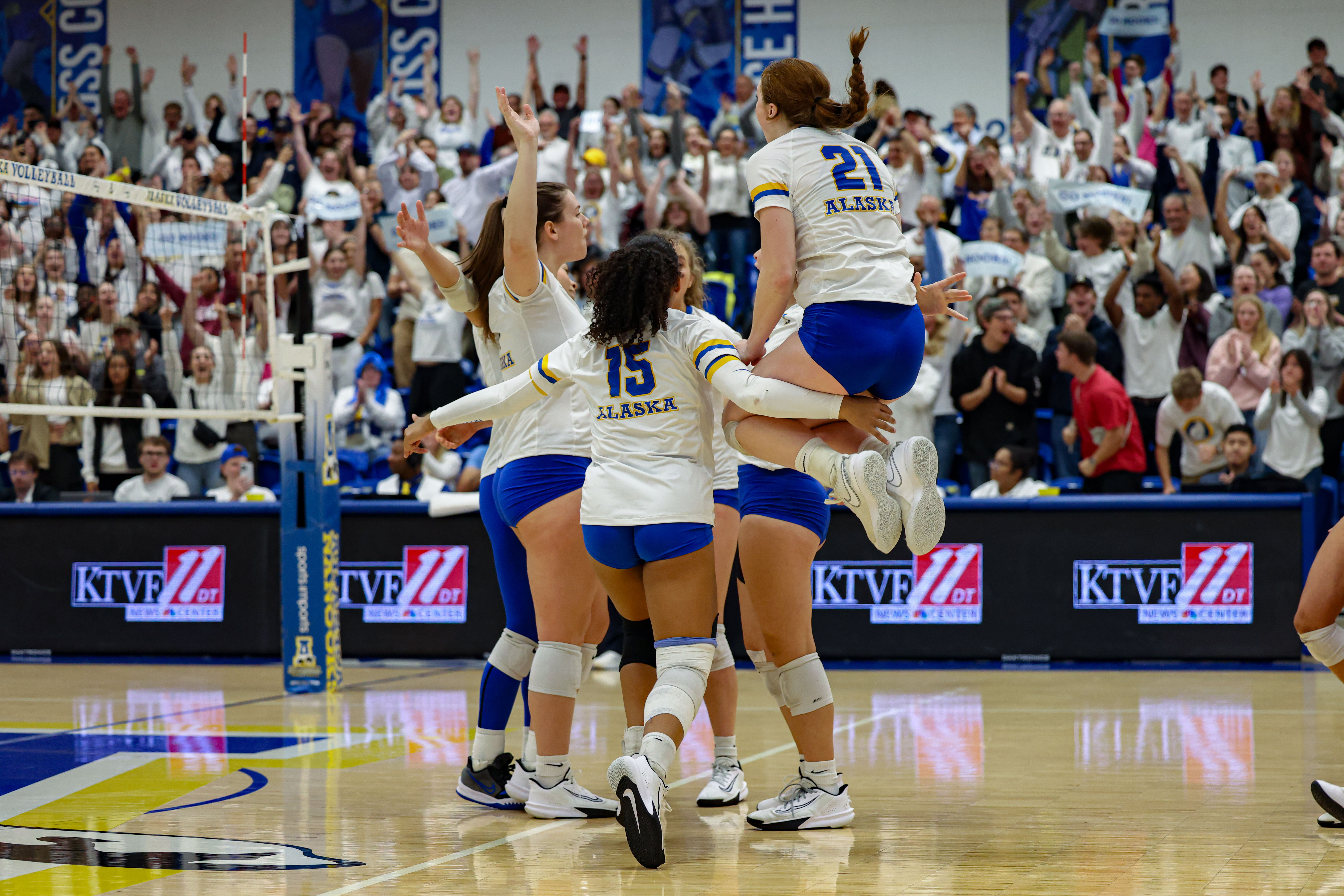 The UAF volleyball team celebrates a point against UAA at Pack the Patty night.