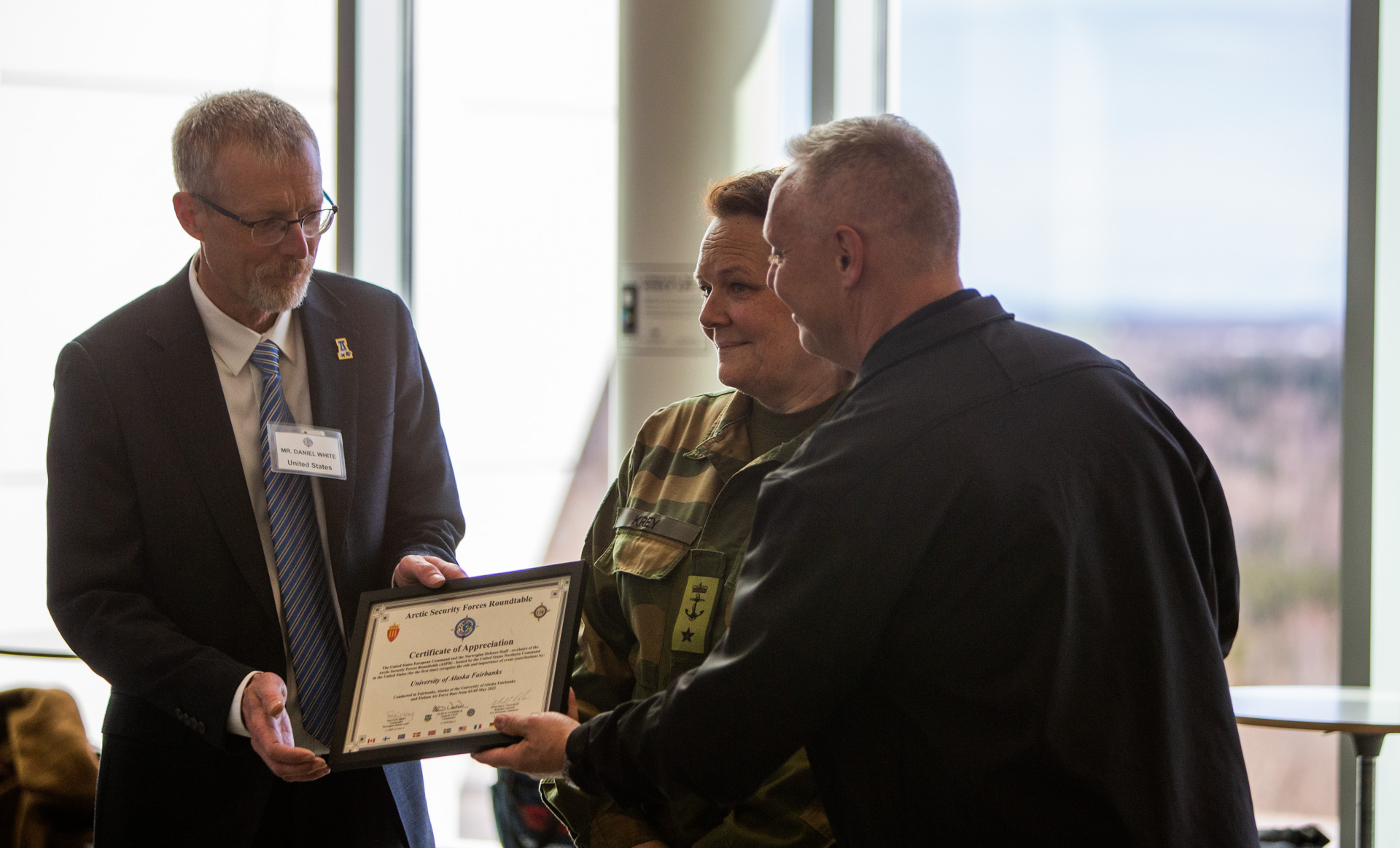 Rear Adm. Dan “Undra” Cheever, at right, presents a certificate of appreciation to UAF Chancellor Dan White.