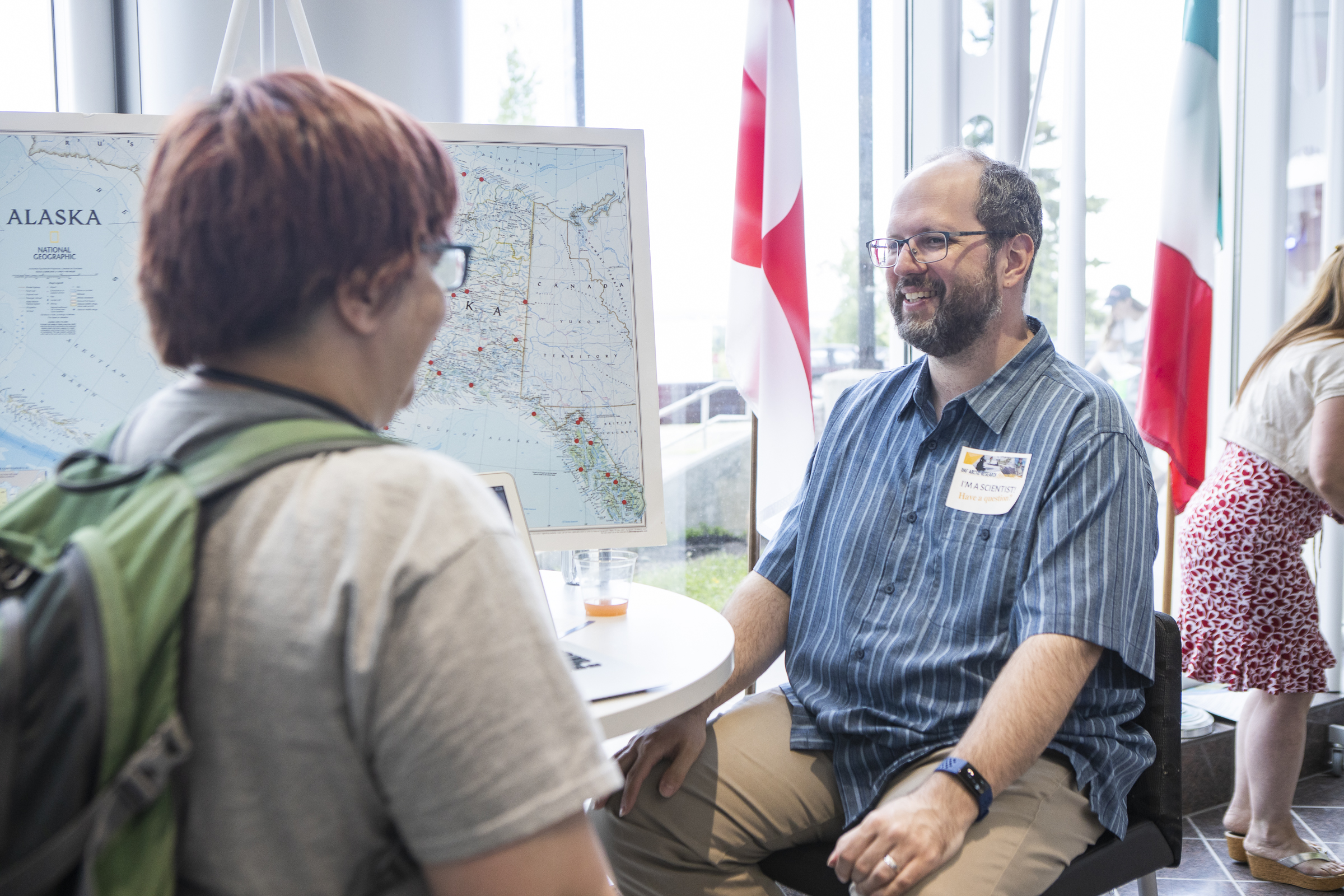 A man talks to a visitor during an open house