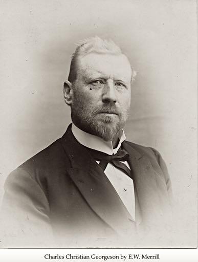 A man with a short blond haircut an beard poses for a portrait in a tuxedo.