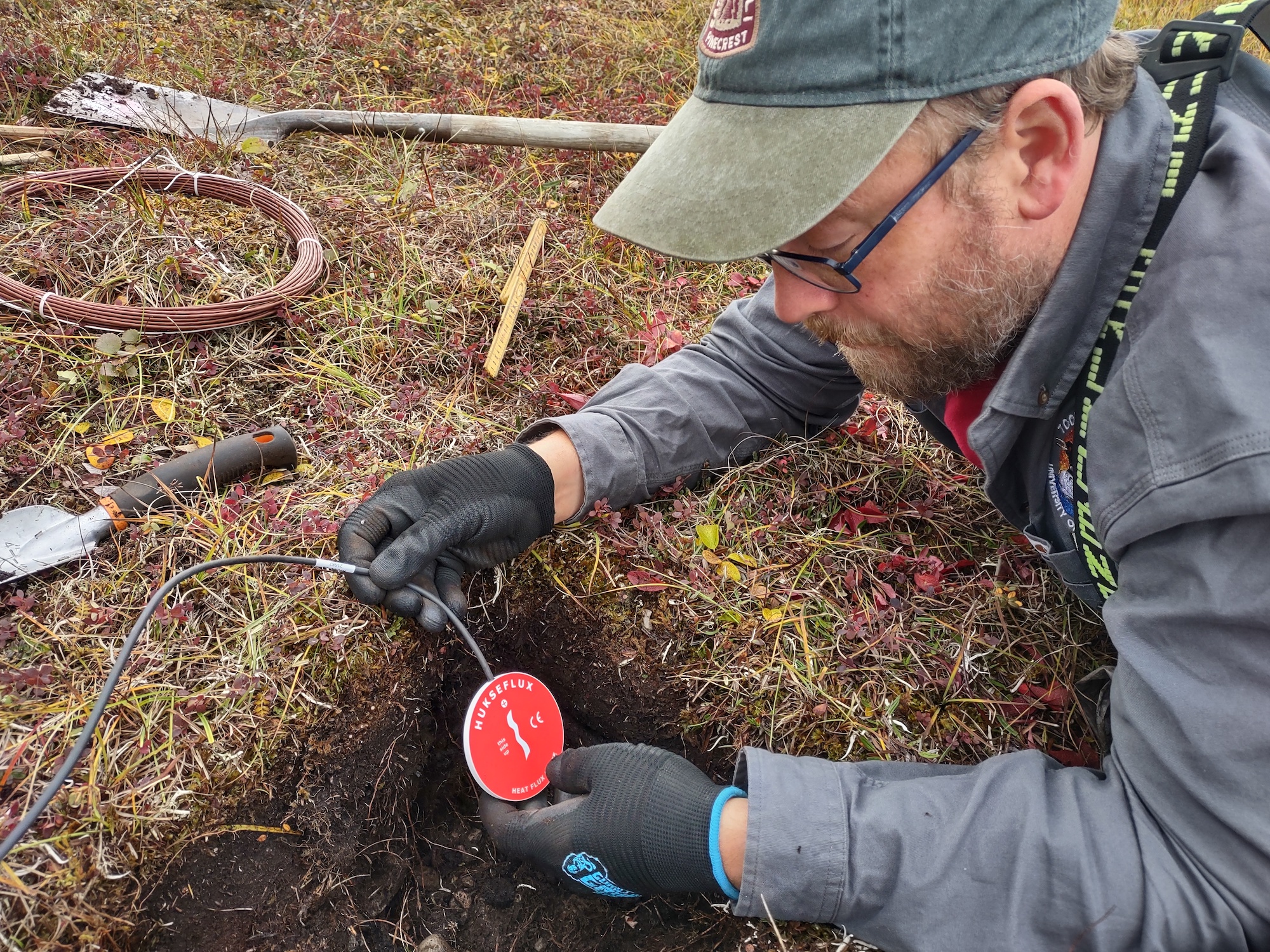 Environmental Data Center technician Colin Edgar installs equipment to measure soil heat exchange for the European Union’s Arctic Passion project at Toolik Field Station in September 2023.