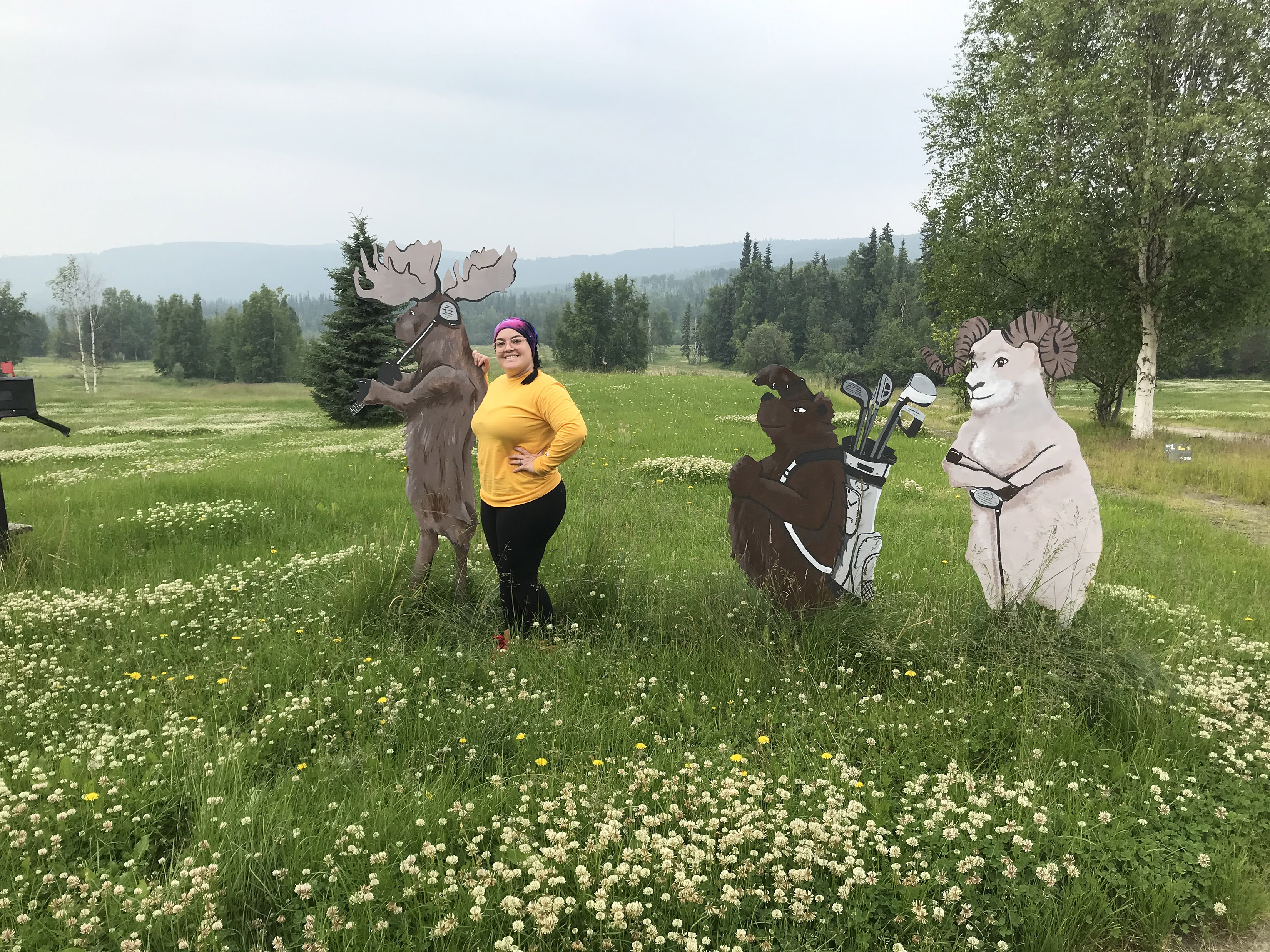 Cristina Ornelas in a field of white clover while doing fieldwork in Fairbanks, Alaska.  