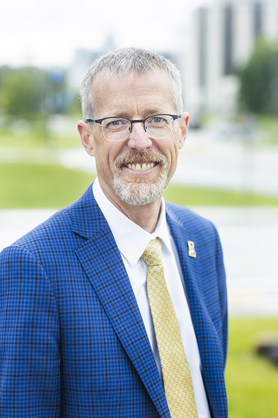 Smiling man with beard and blue suit