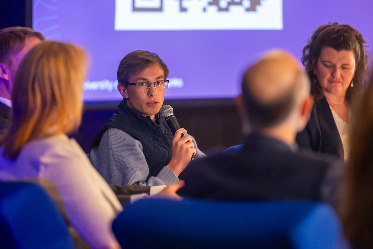 Jackson Nelson speaks as UAF Interim Chancellor Mike Sfraga, Lisa Putnam, board chair, Greater Fairbanks Chamber of Commerce and UAF Board of Advisors member, UA Director of State Relations Chad Hutchison, Associated Students of the University of Alaska Fairbanks President Jackson Nelson, and Theresa Bakker, director of Development and Alumni Relations, and executive director of the UAF Alumni Association, participate in the Chancellor's Legislative Kickoff forum, Jan. 15, 2026 in the Wood Center Ballroom.