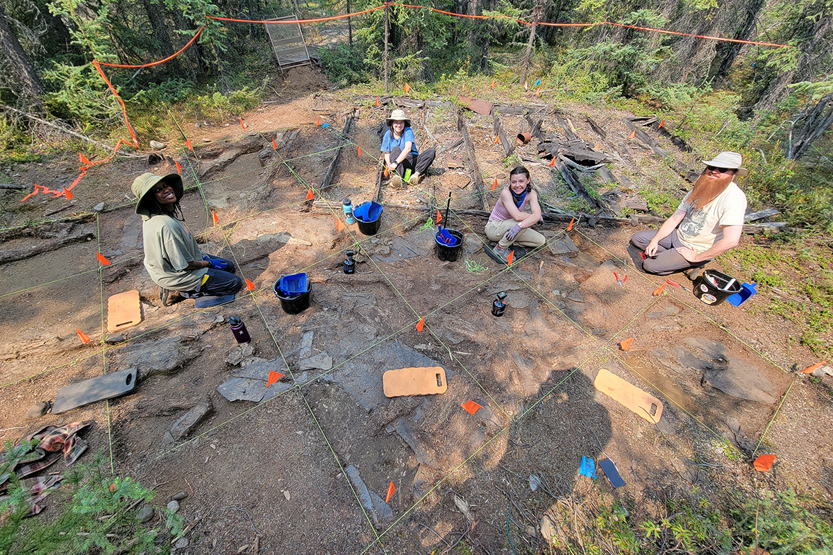 Alaska Highway Archaeological Field School students in Tok, Alaska, excavating an outhouse. From left to right: T. Watson-Glen, Amilia Galdiano, Meg Whitton, Austin Sweeney.