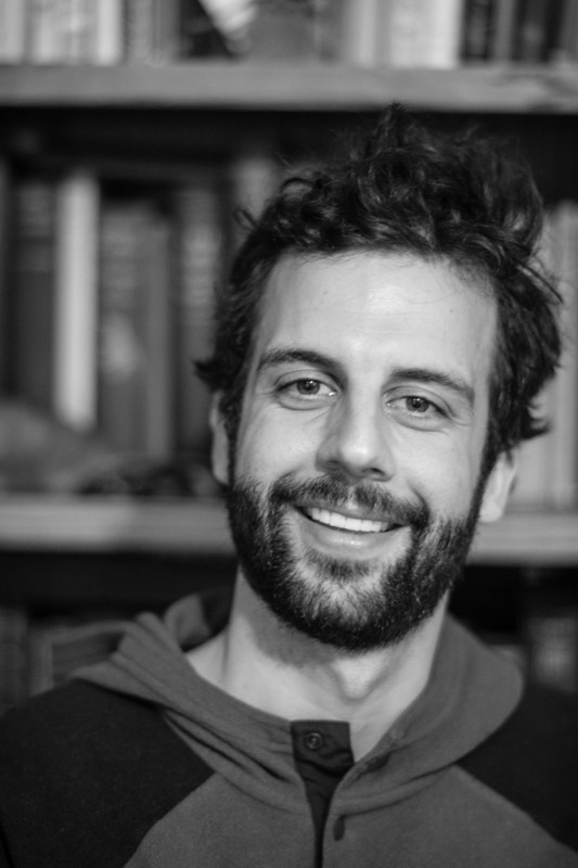 Black and white photo of a smiling bearded man