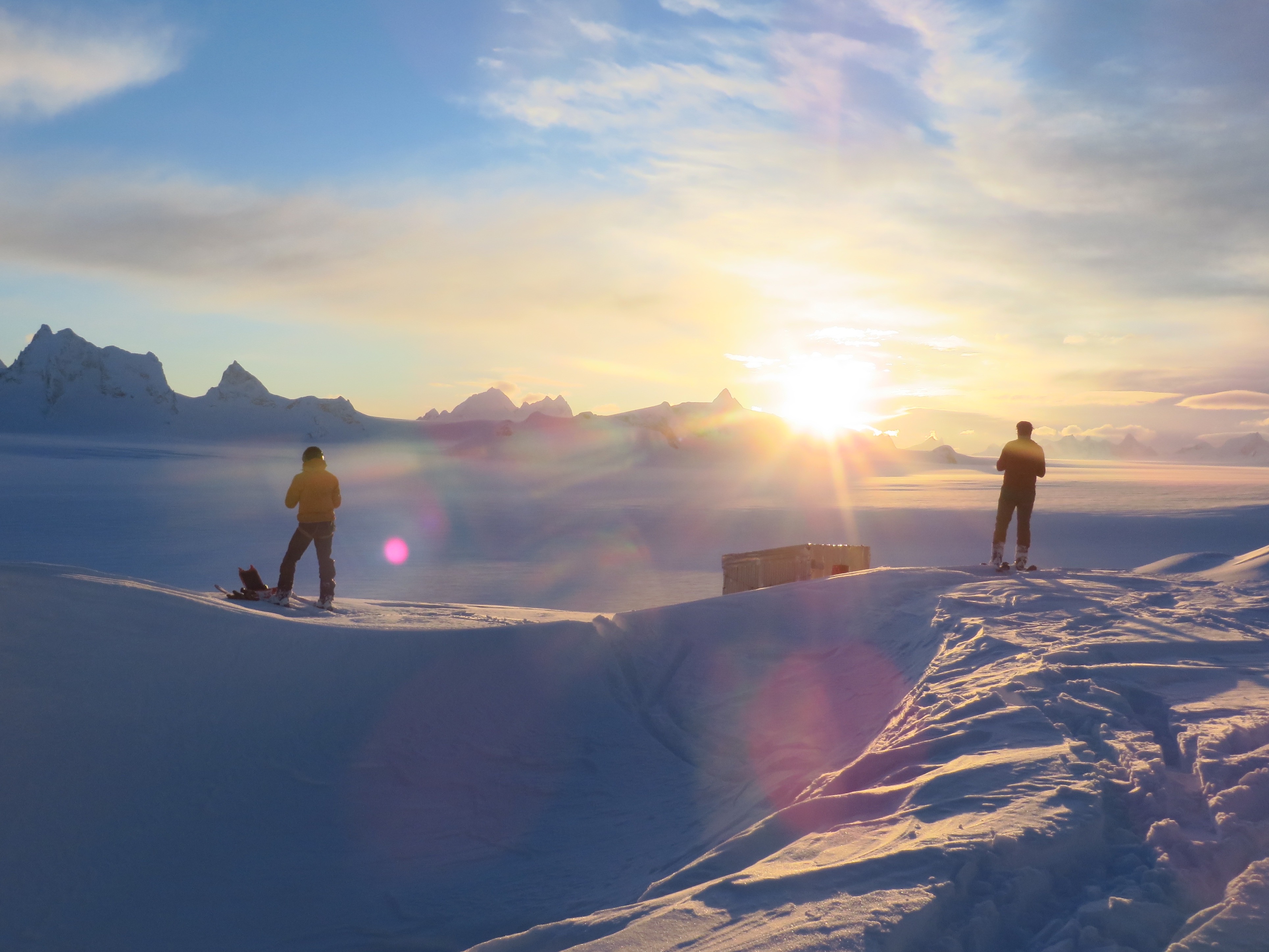Scientists stand on an icefield. 