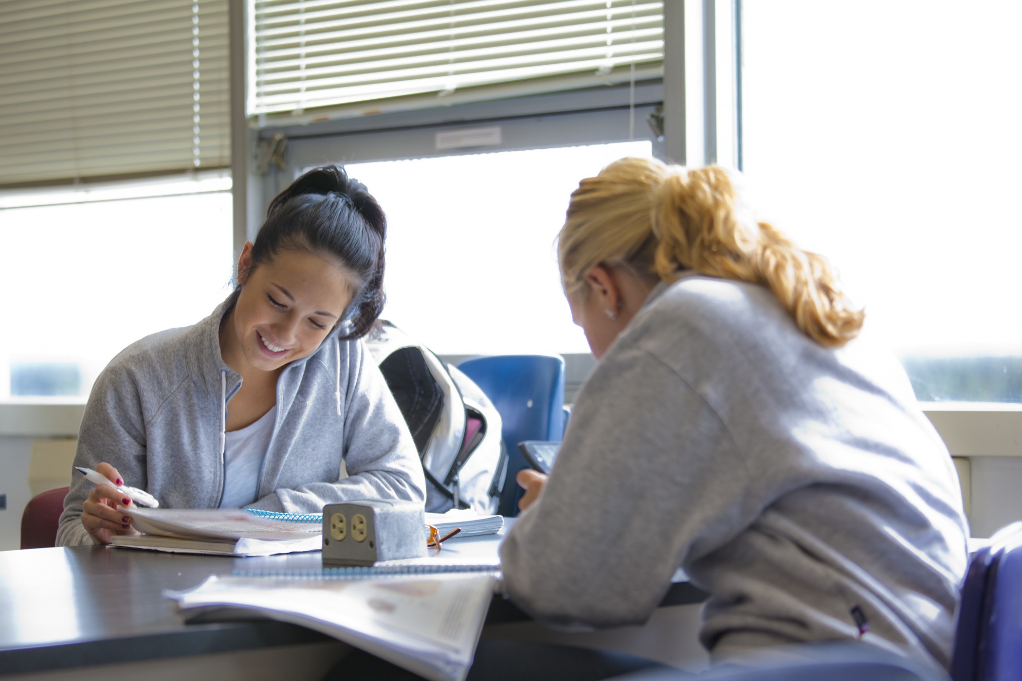 Two women study together at a table