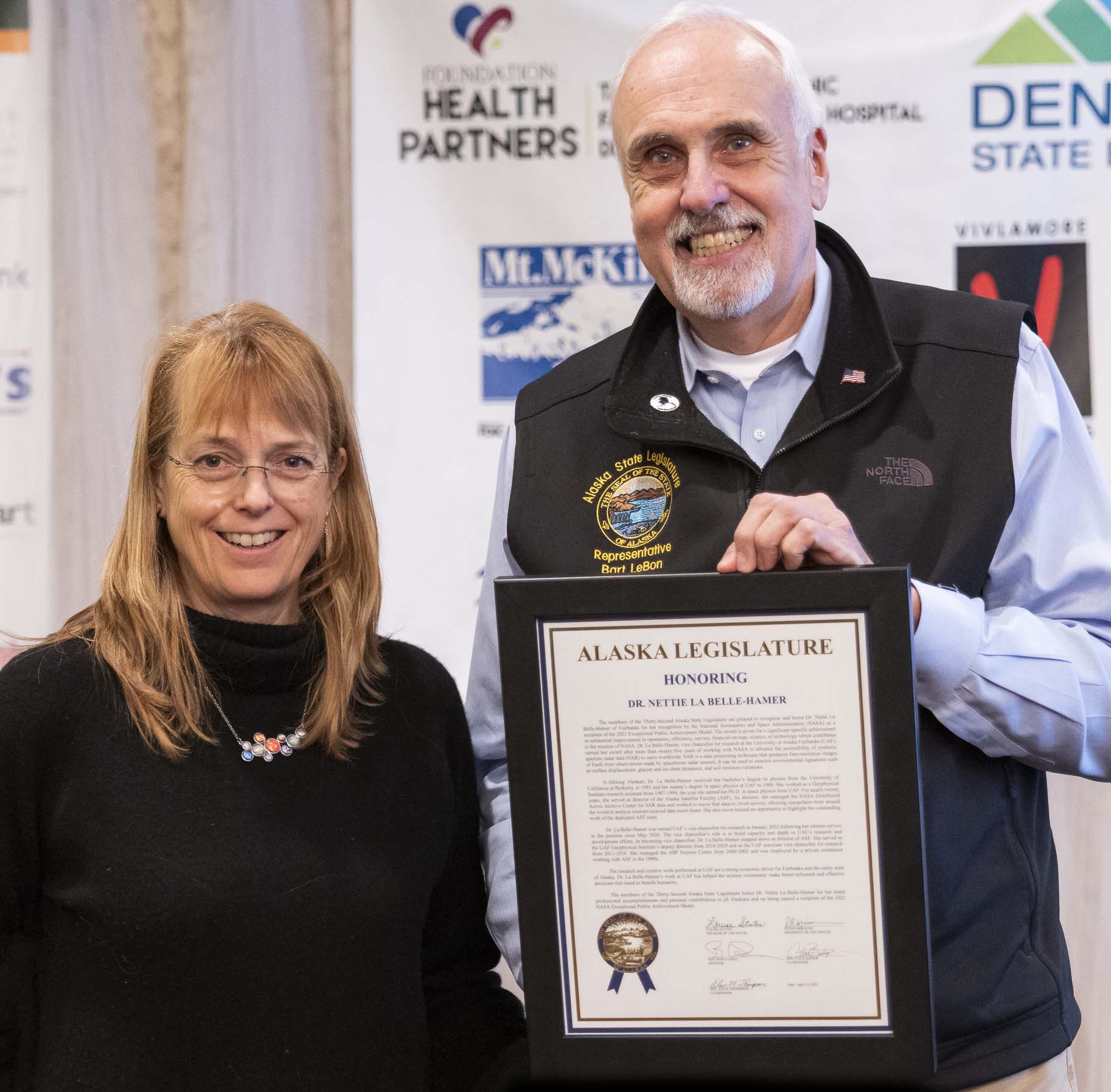Rep. Bart LeBon presenting a Alaska legislative citation to UAF Vice Chancellor for Research Nettie La Belle-Hamer.