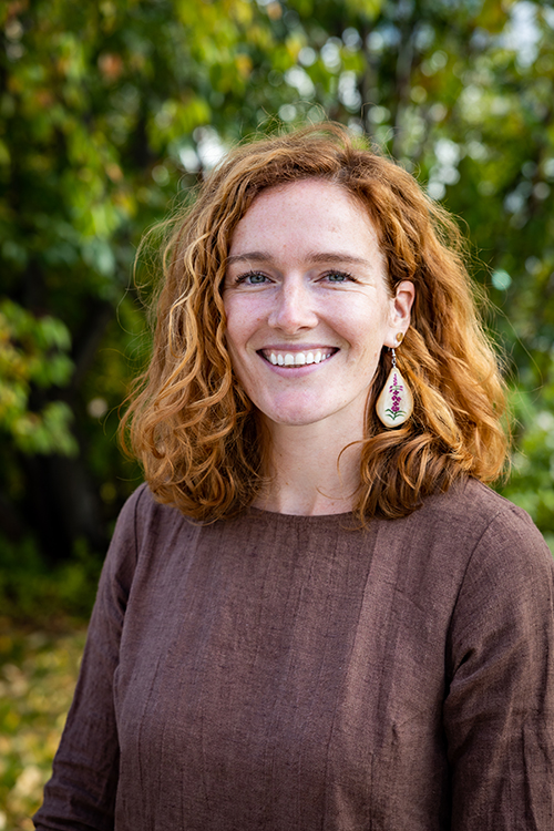 Head and shoulders photo of Brittany Van Eck taken outside.