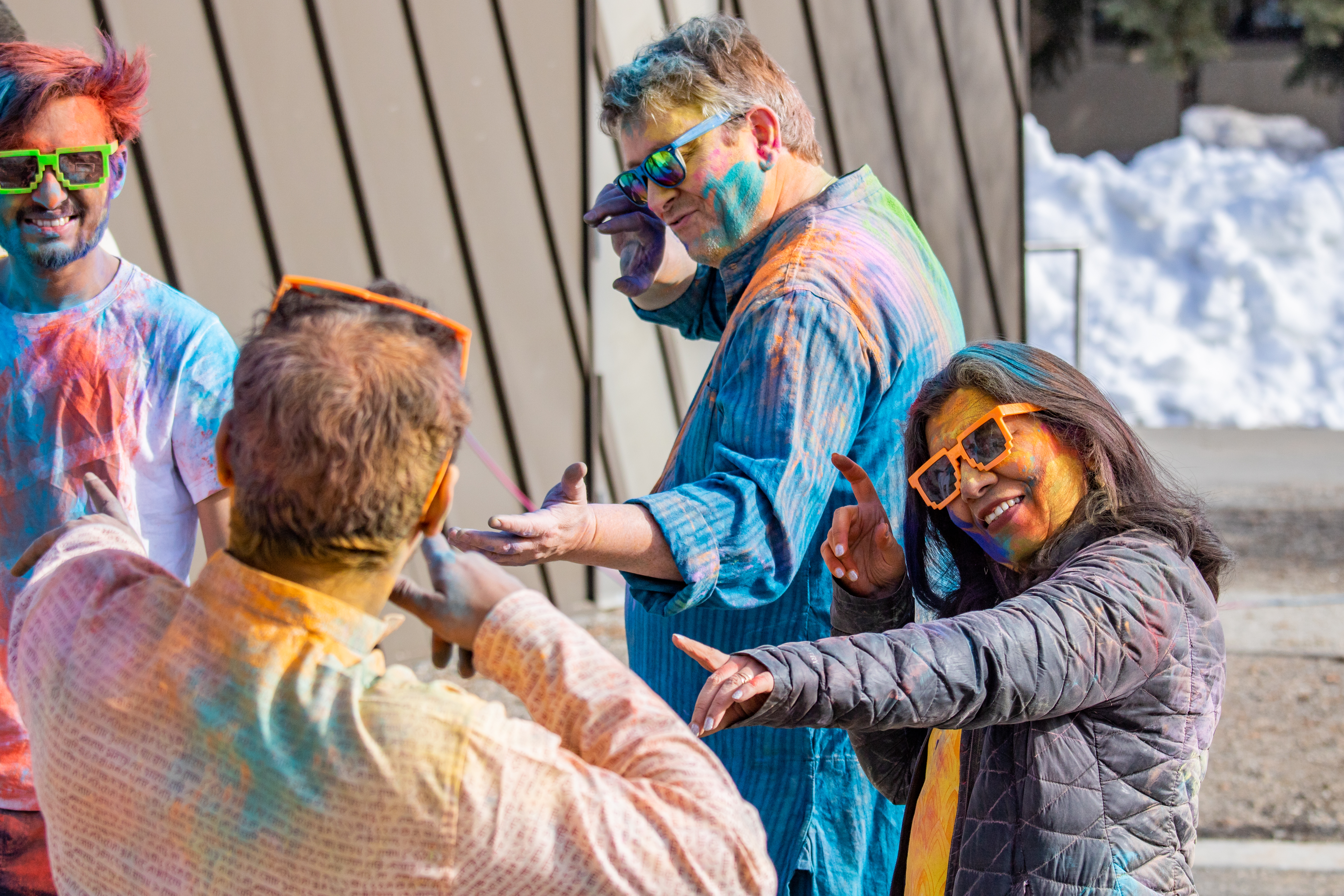Provost Prakash (right) and her husband Rudi Gens (middle) dancing with students and community members during the UAF Holi 2024 celebrations.
