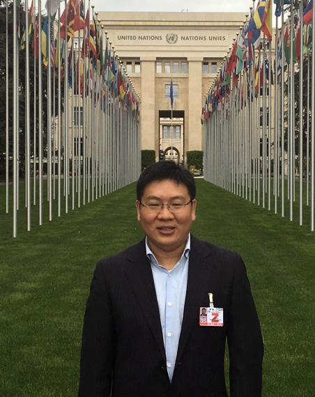 Man standing in front of the United Nations Building