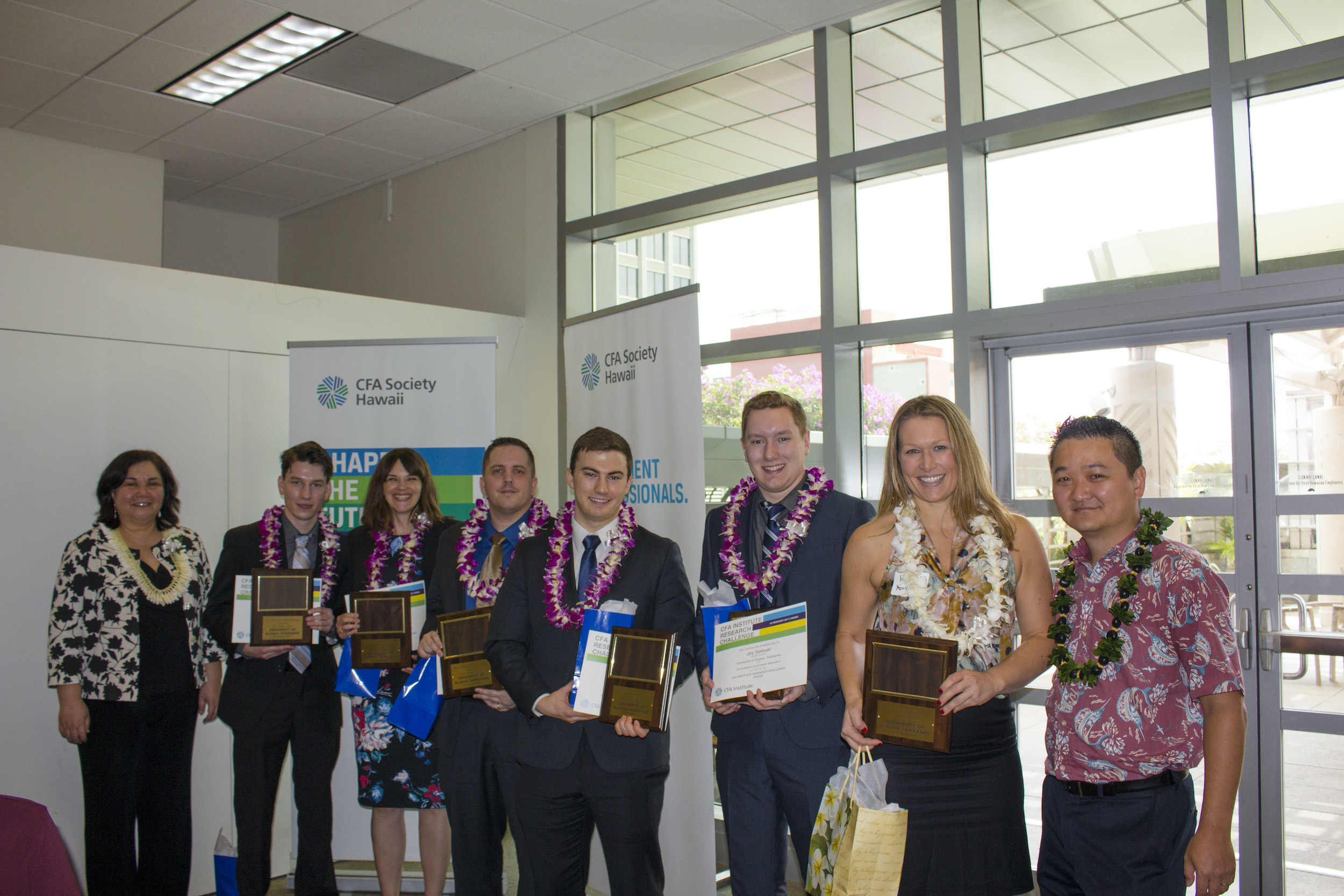 Kim McGinnis (second from right) displays the CFA (Chartered Financial Analyst) Institute Research Challenge Awards given to students at the CFA Society Hawaii Conference in February 2017.