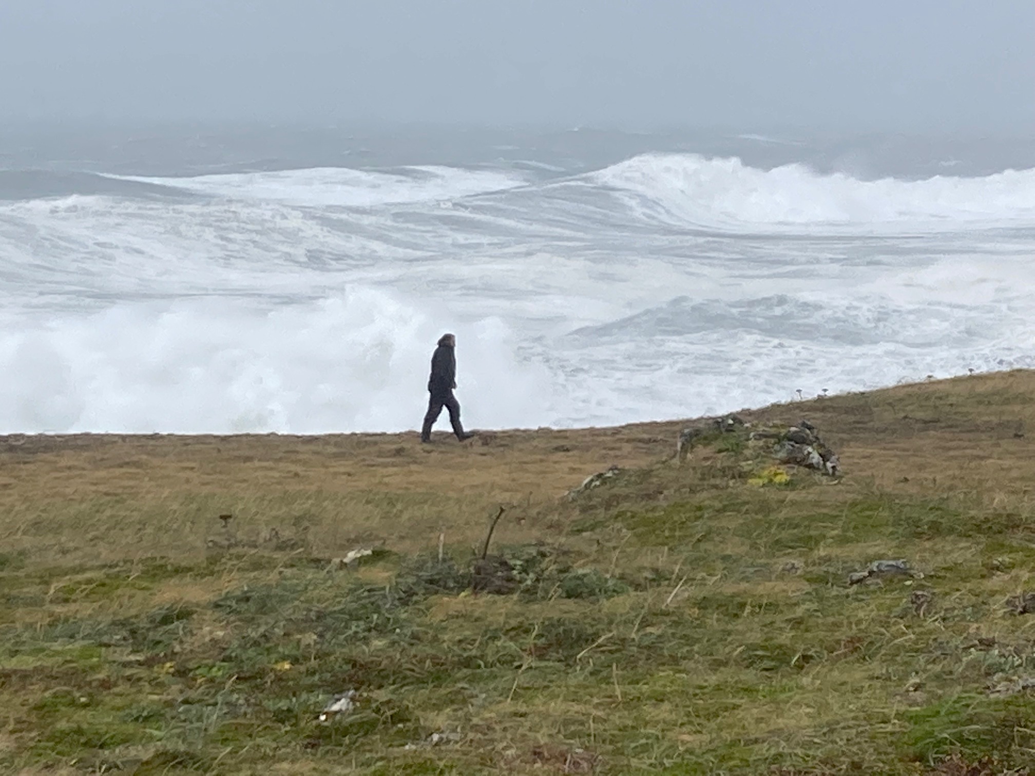 Filmmaker walks at edge of St. Paul Island