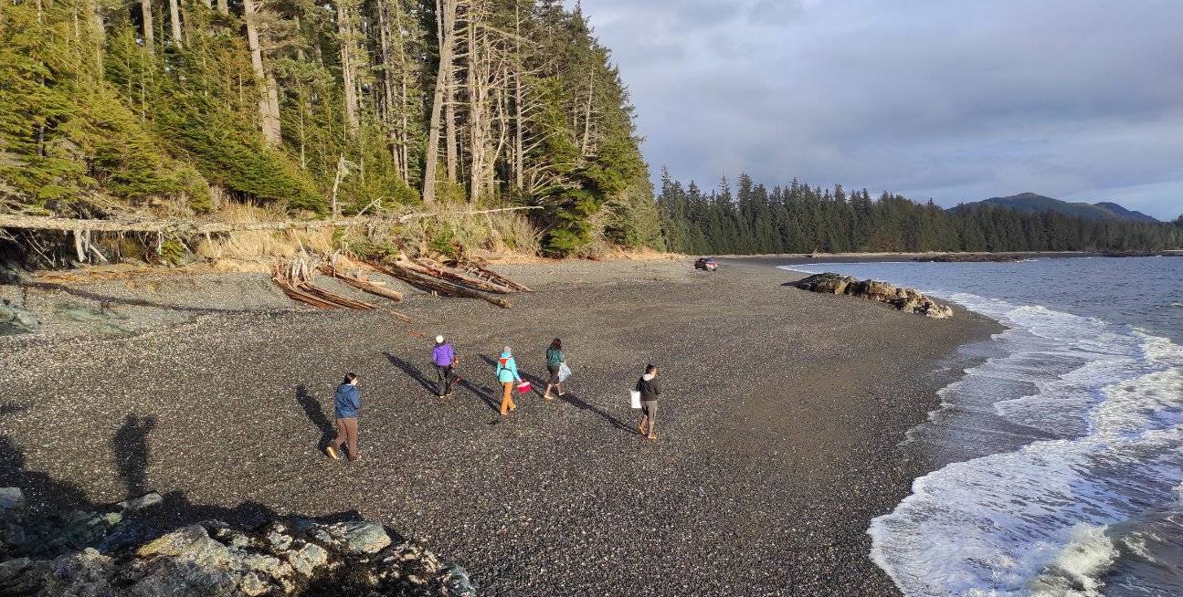 Local residents walk a beach on Kupreanof Island, just north of the community of Kake,  during field work for the Kake Climate Partnership. 